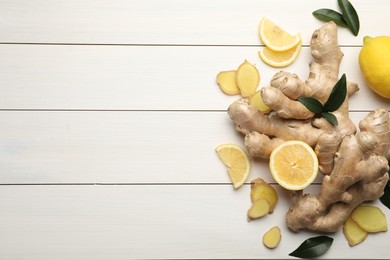 Fresh lemons and ginger on white wooden table, flat lay. Space for text