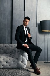 Photo of Handsome businessman in stylish living room. Luxury lifestyle