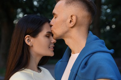 Photo of Affectionate young couple having good time together outdoors