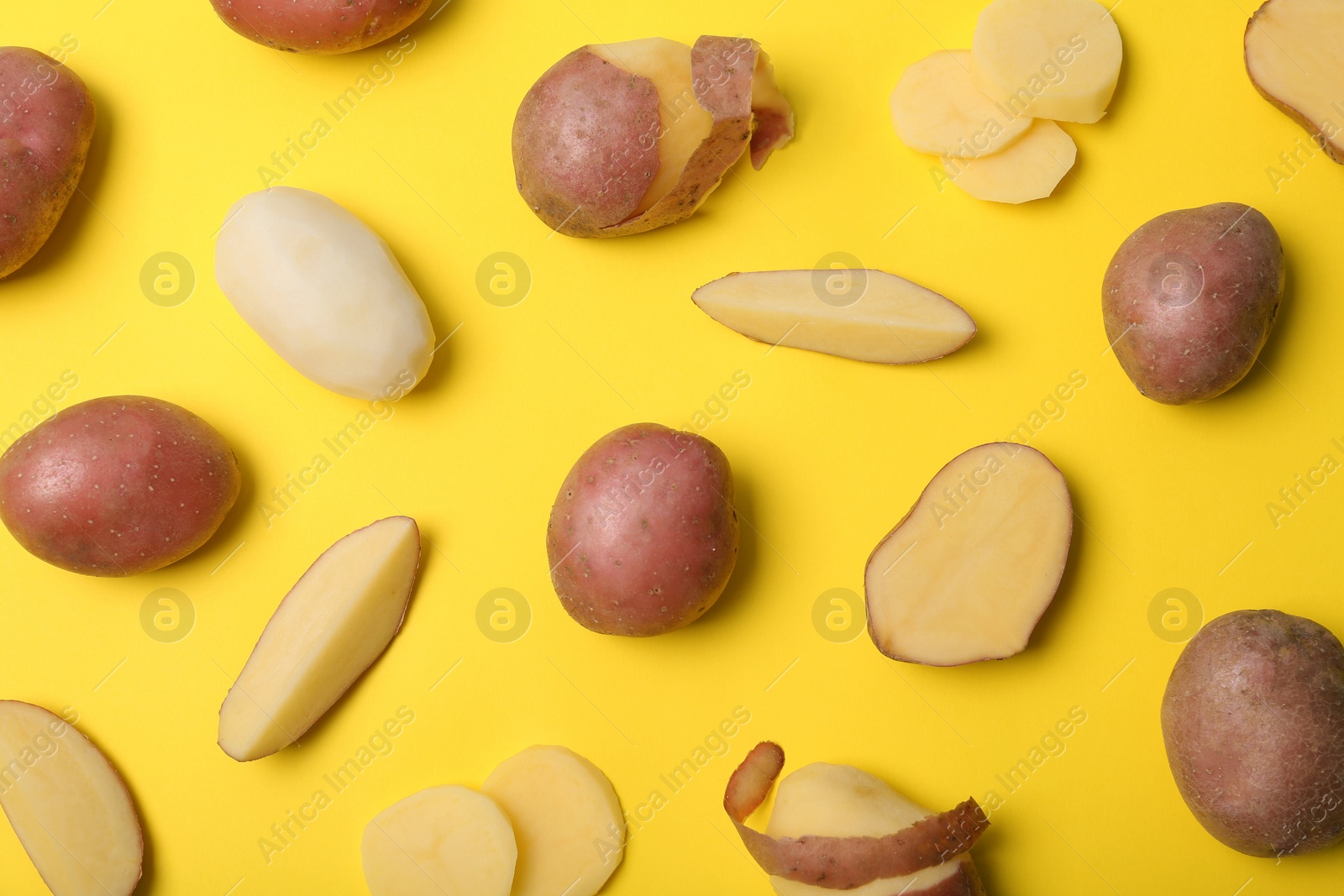 Photo of Flat lay composition with fresh organic potatoes on color background