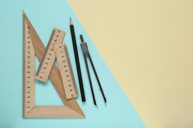 Photo of Different rulers and compass on color background, flat lay. Space for text