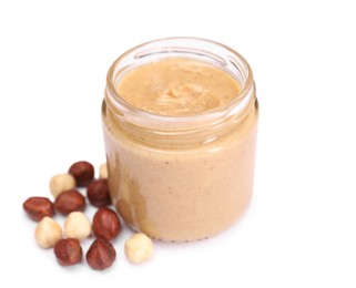 Photo of Tasty nut paste in jar and hazelnuts isolated on white