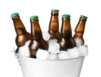 Metal bucket with bottles of beer and ice cubes on white background