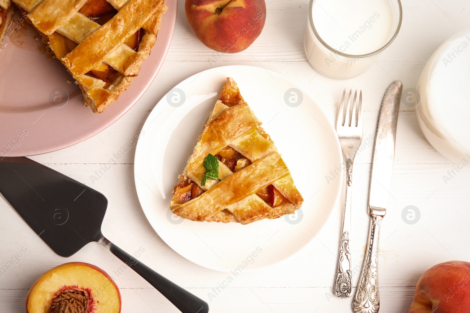 Photo of Piece of delicious fresh peach pie served on white wooden table, flat lay