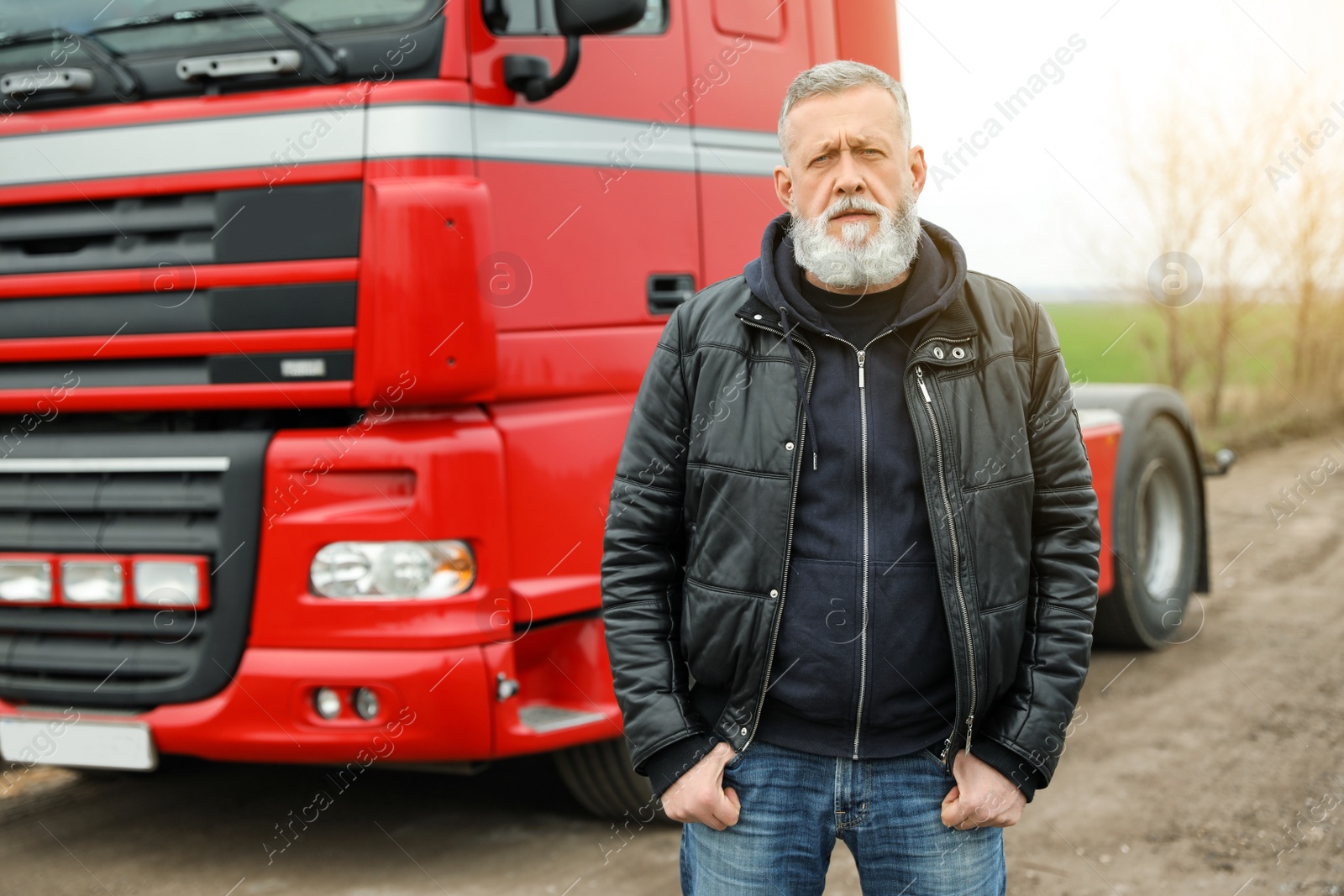 Photo of Portrait of mature driver at modern truck outdoors