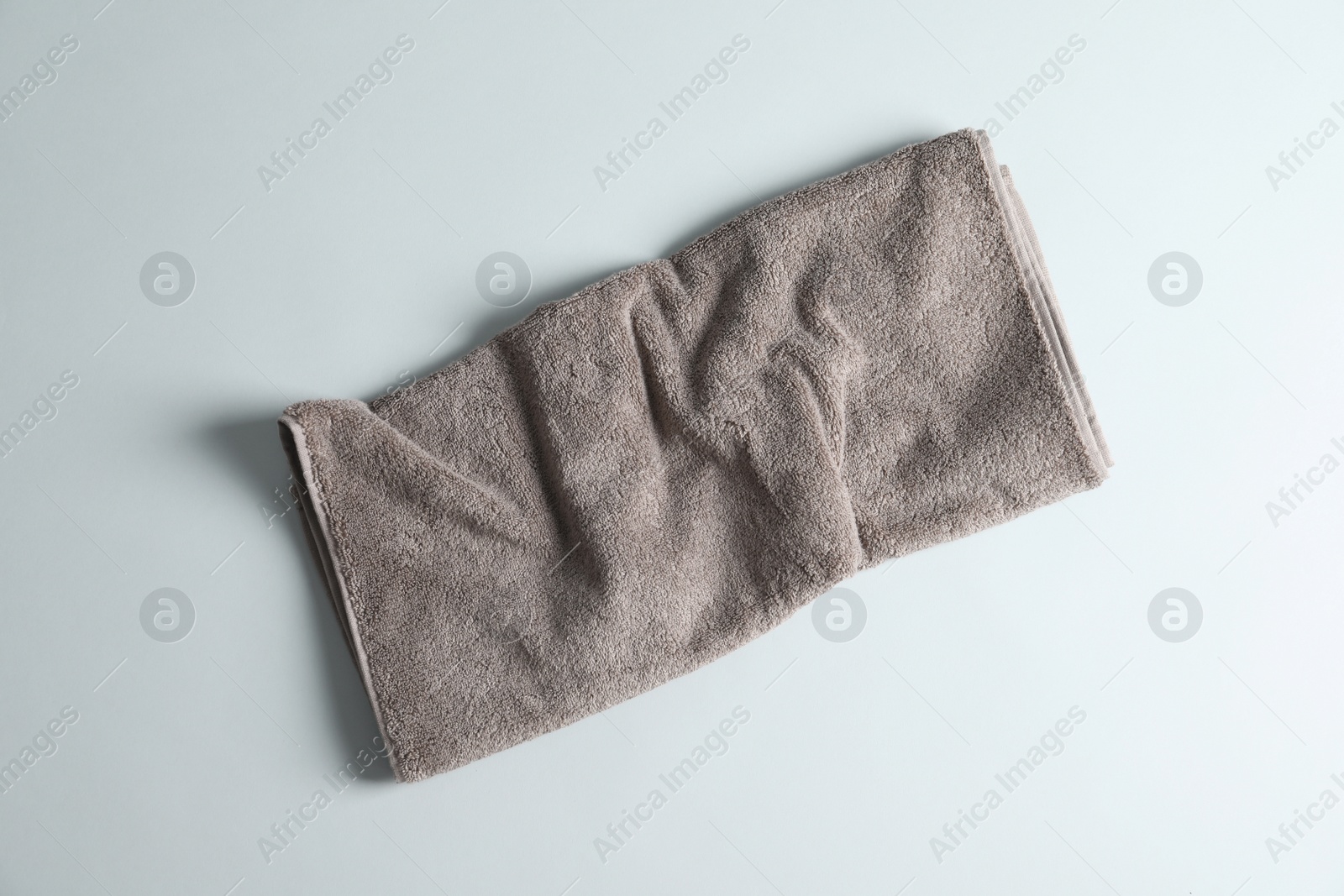 Photo of Fresh fluffy towel on grey background, top view