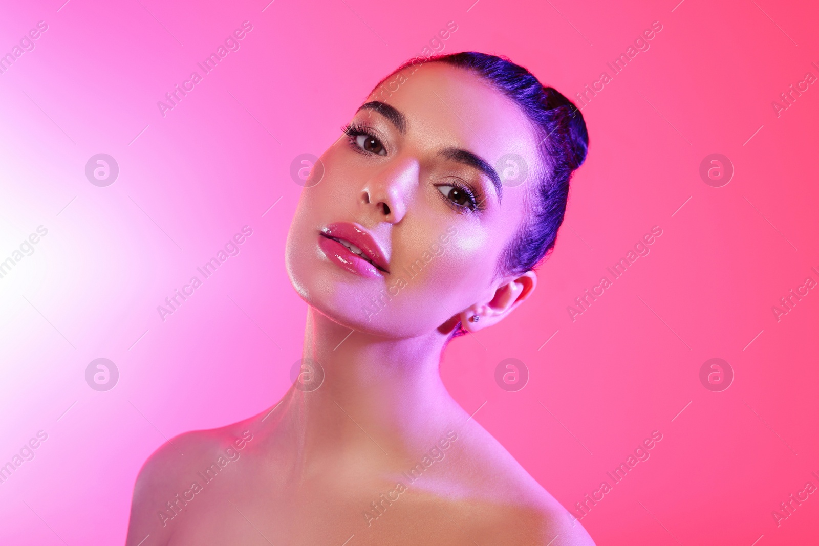 Photo of Beautiful young woman posing on pink background