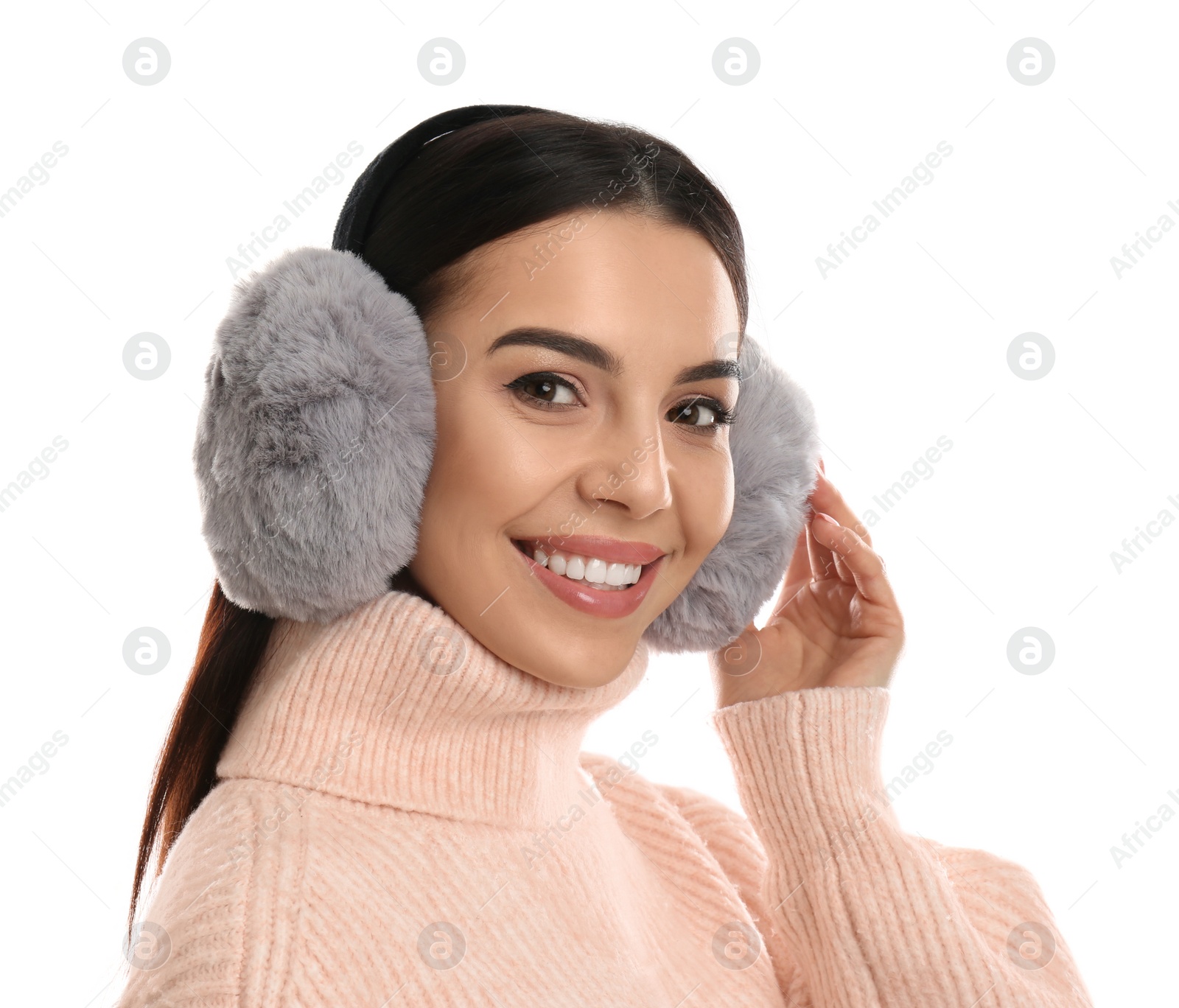 Photo of Beautiful young woman wearing earmuffs on white background