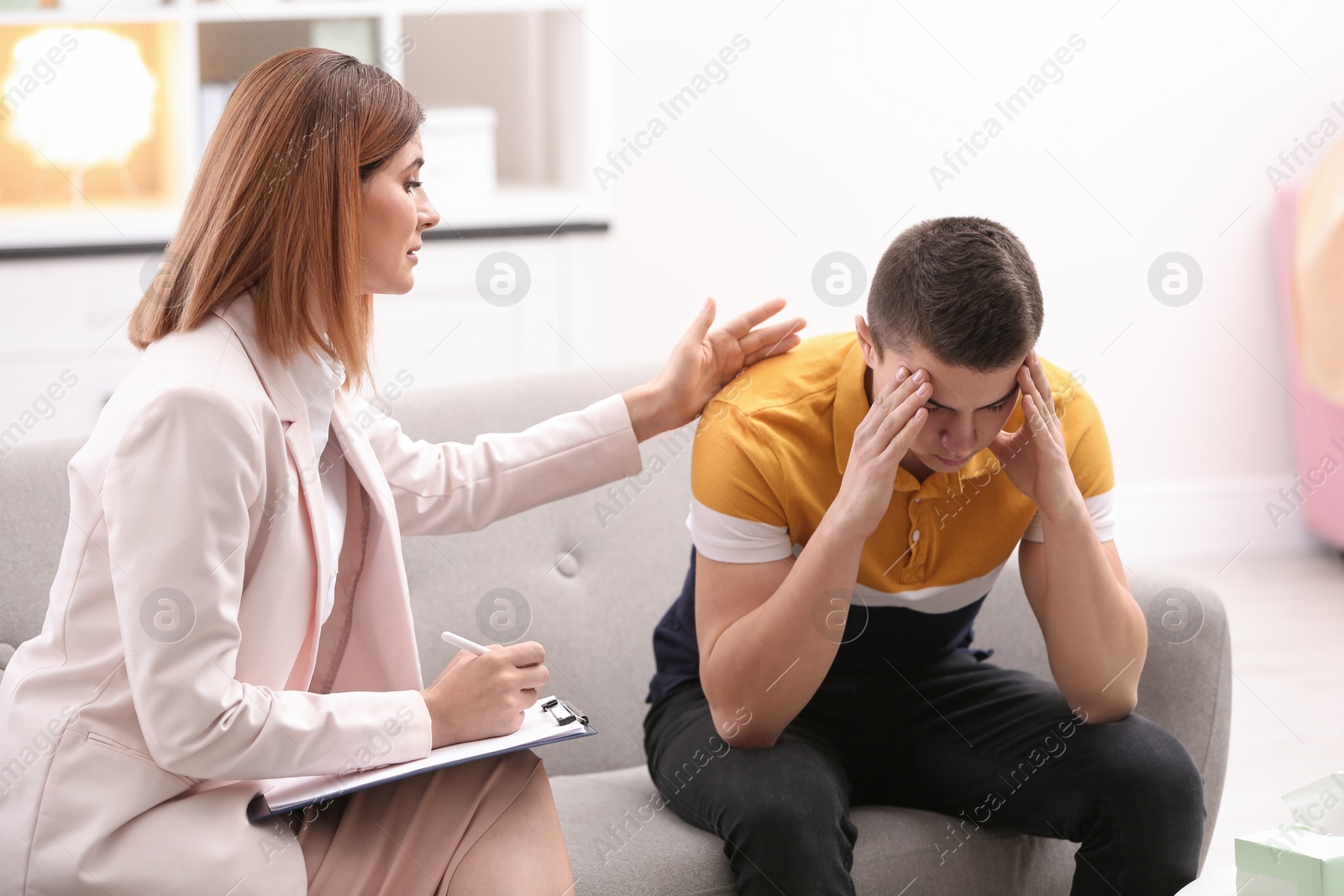 Photo of Psychotherapist working with young man in office