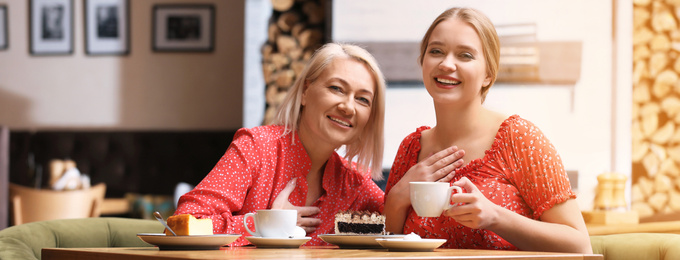 Image of Mother and her adult daughter spending time together in cafe. Banner design