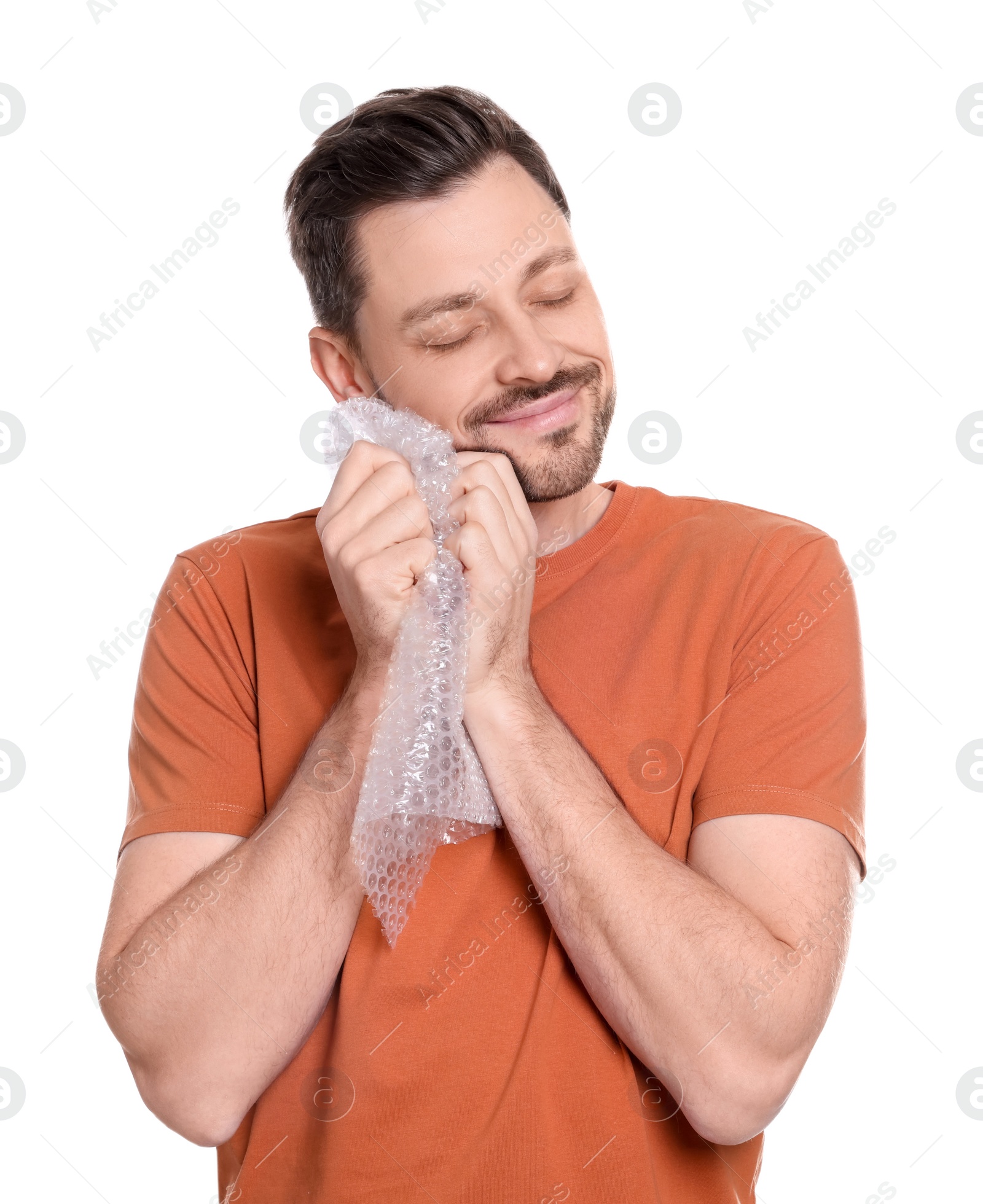 Photo of Man popping bubble wrap on white background. Stress relief