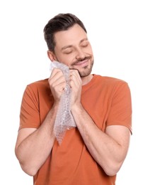 Man popping bubble wrap on white background. Stress relief