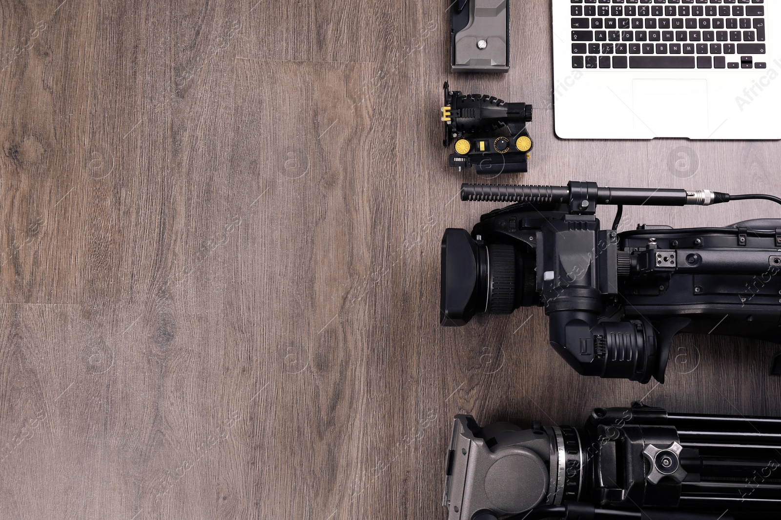Photo of Flat lay composition with video camera and other equipment on wooden table. Space for text