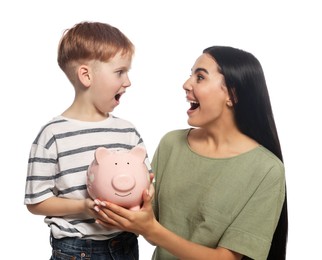 Mother and her son with ceramic piggy bank on white background