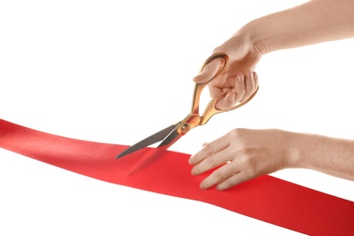 Woman cutting red ribbon on white background