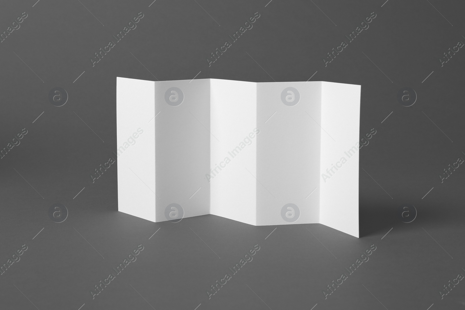 Photo of Blank brochure on gray background. Mock up for design