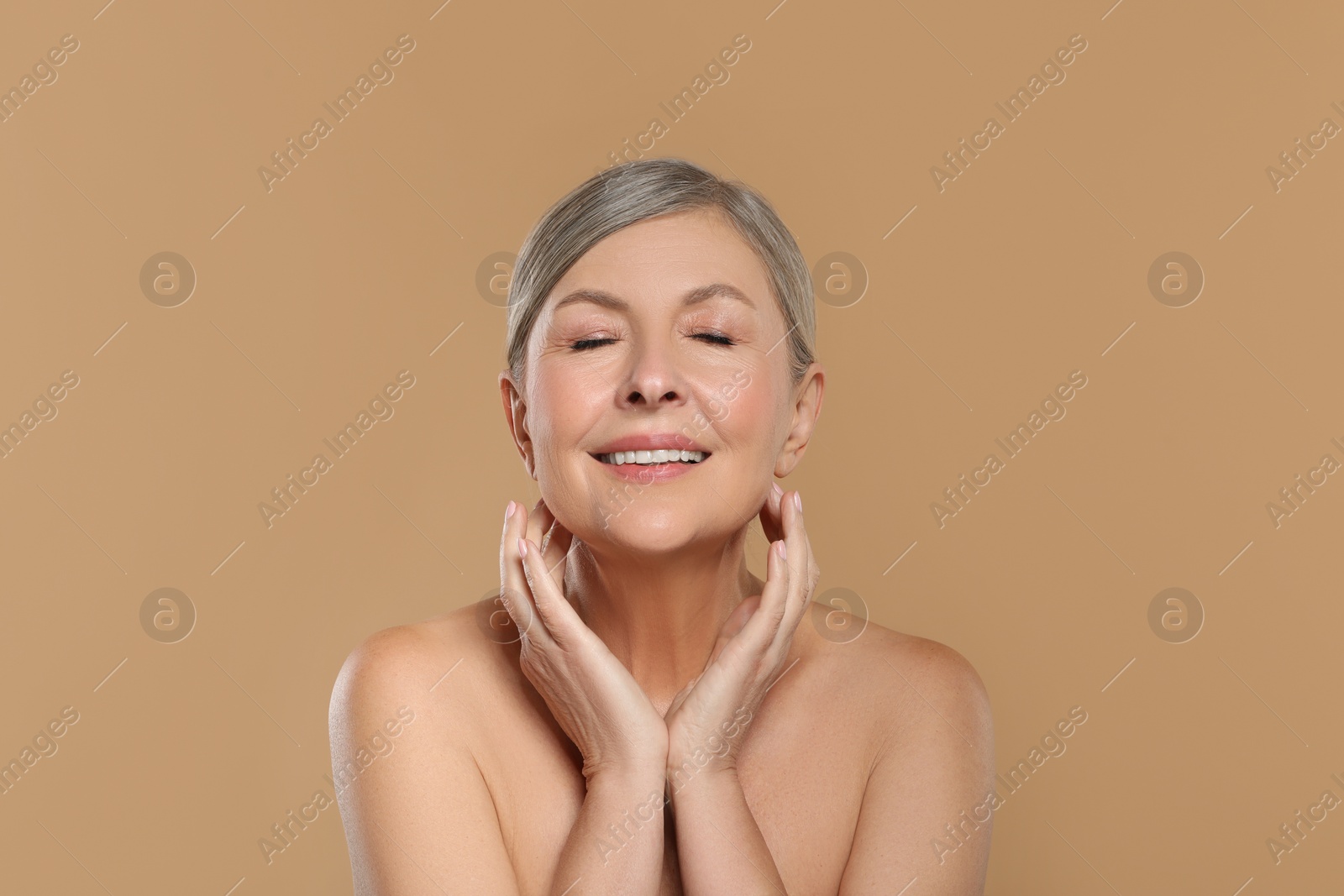 Photo of Beautiful mature woman with healthy skin on beige background