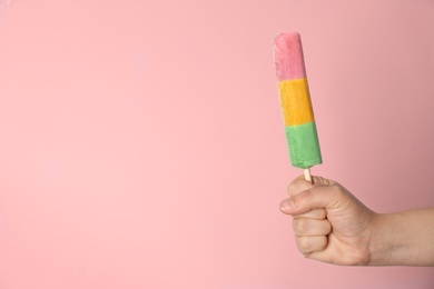 Photo of Woman holding delicious ice cream against color background, space for text