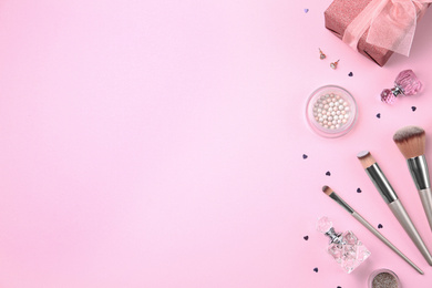 Photo of Flat lay composition with cosmetics and stylish accessories on pink background. Space for text