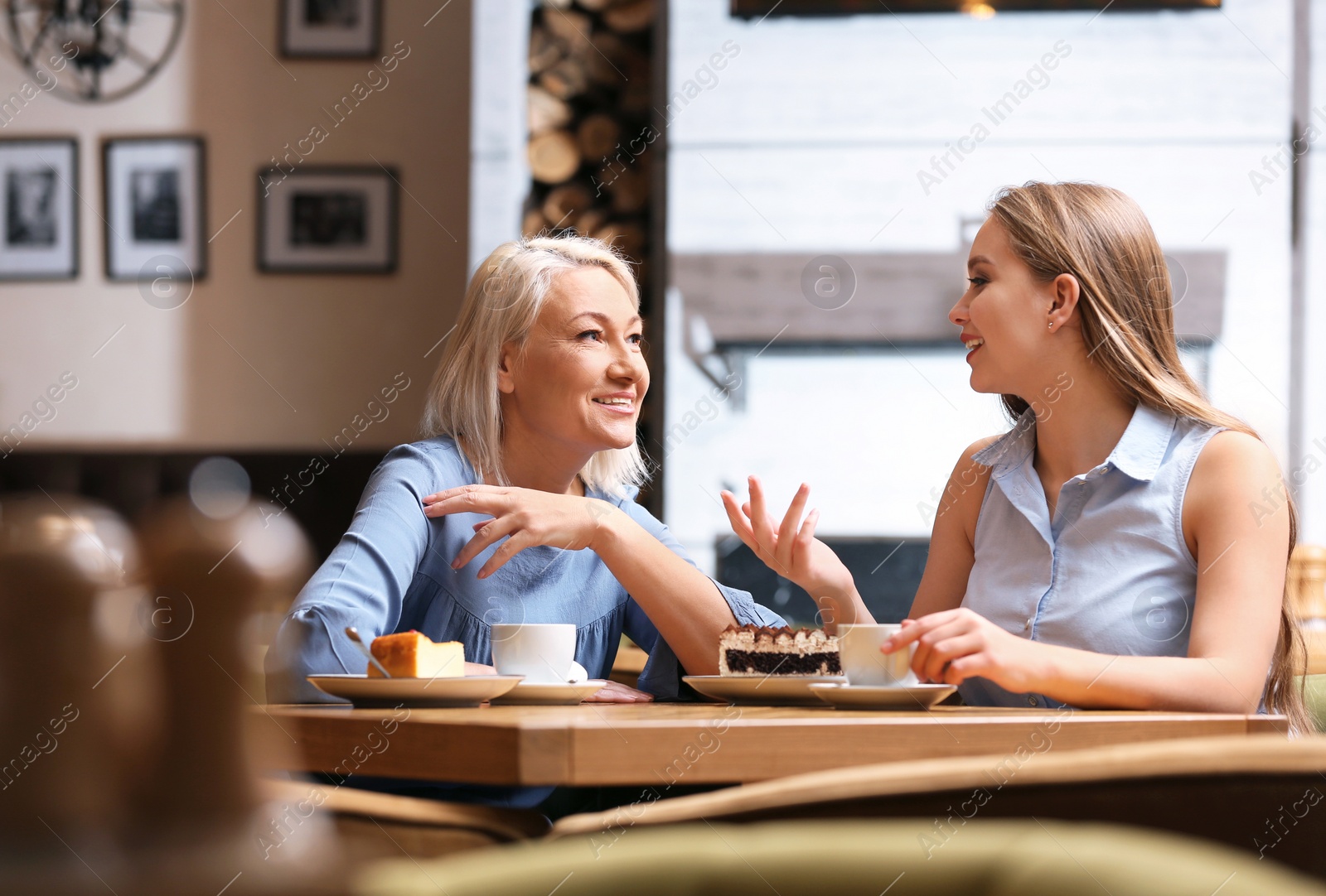 Photo of Mother and her adult daughter spending time together in cafe