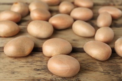 Raw jackfruit seeds on wooden table, closeup