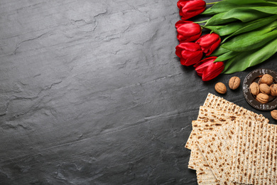 Flat lay composition with traditional Pesach (Passover Seder) matzo on grey table. Space for text