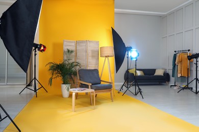 Stylish furniture in photo studio with professional equipment