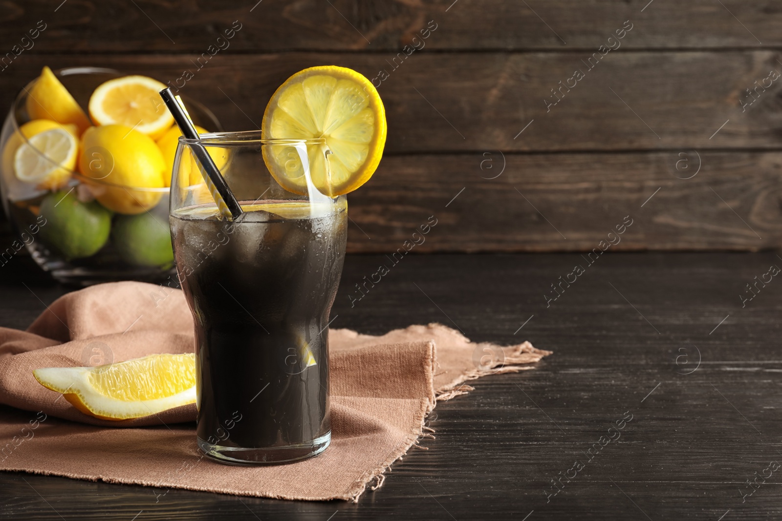 Photo of Glass with natural black lemonade on table