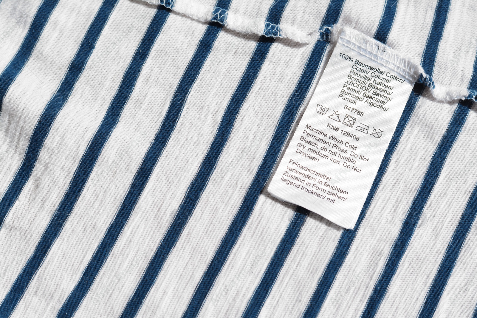 Photo of Clothing label on striped garment, top view