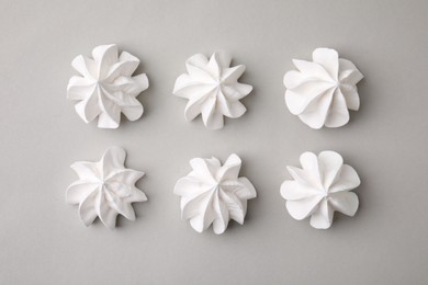 Photo of Tasty meringue cookies on light grey background, flat lay