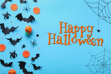Image of Halloween decor elements on light blue background, flat lay