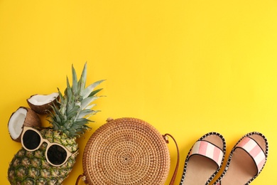 Photo of Flat lay composition with bamboo bag, beach items and space for text on color background