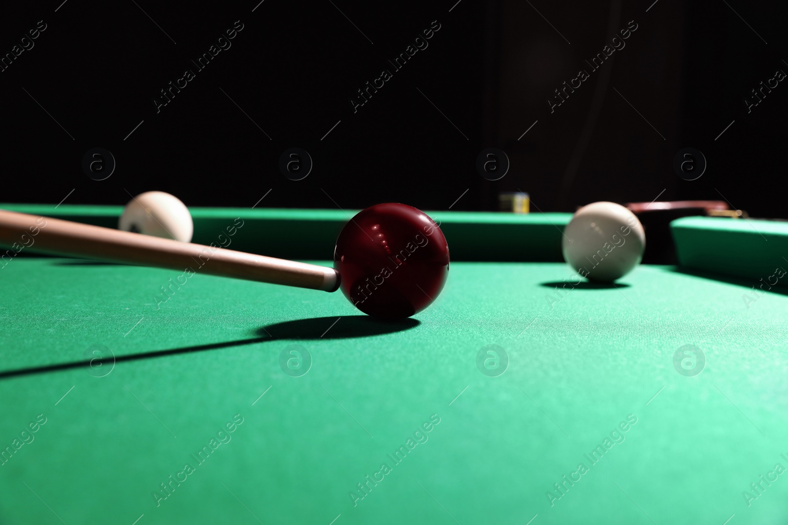 Photo of Striking red ball into billiard table pocket