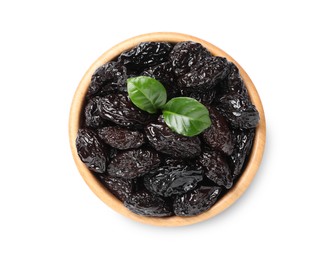 Photo of Wooden bowl with sweet dried prunes and green leaves isolated on white, top view