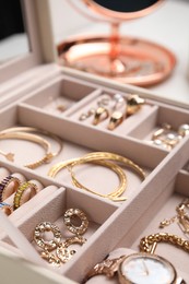 Jewelry box with stylish golden bijouterie, closeup view