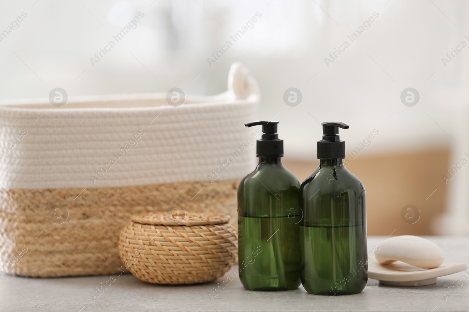 Photo of Green soap dispensers on white countertop in bathroom