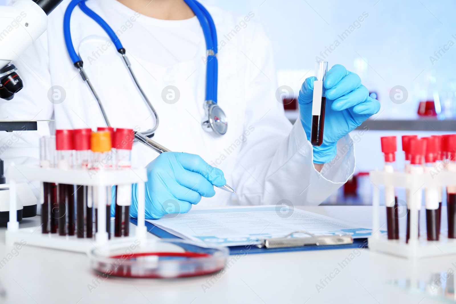 Photo of Female scientist working at table in laboratory. Research and analysis