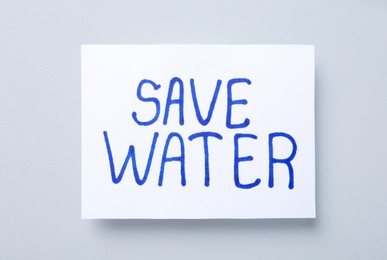 Photo of Card with words Save Water on light grey background, top view