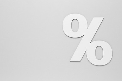 Photo of Paper percent symbol cutout on light grey background, top view. Space for text