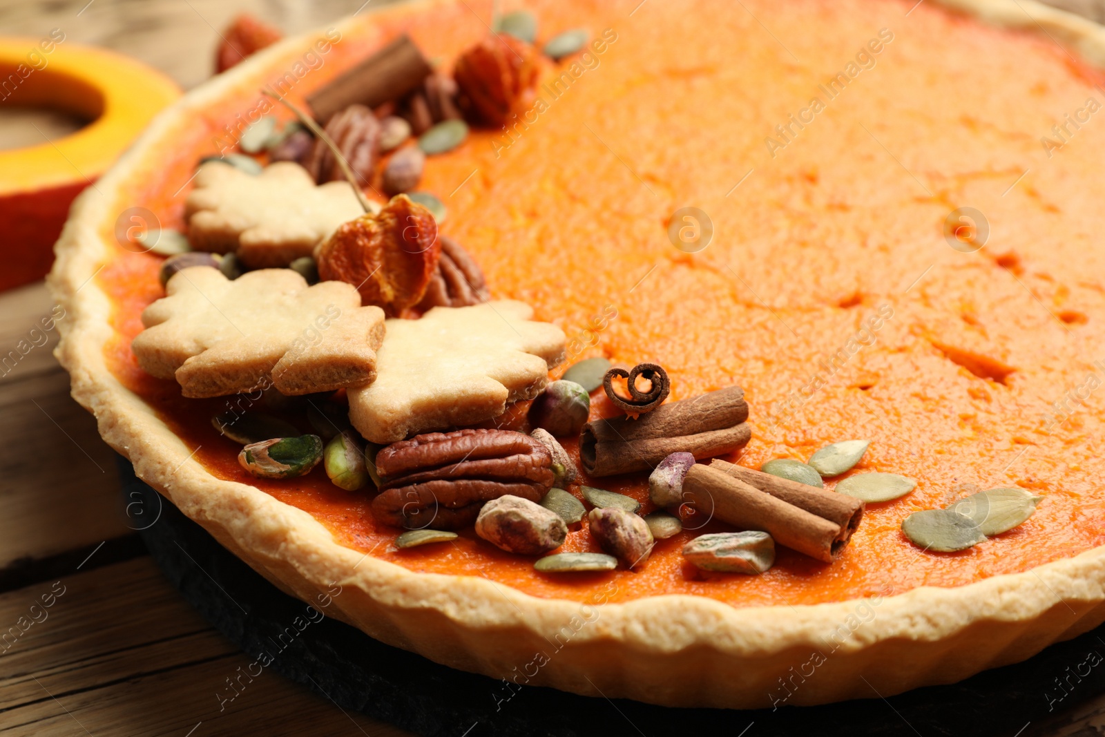 Photo of Delicious homemade pumpkin pie on wooden table, closeup