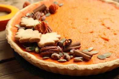 Photo of Delicious homemade pumpkin pie on wooden table, closeup