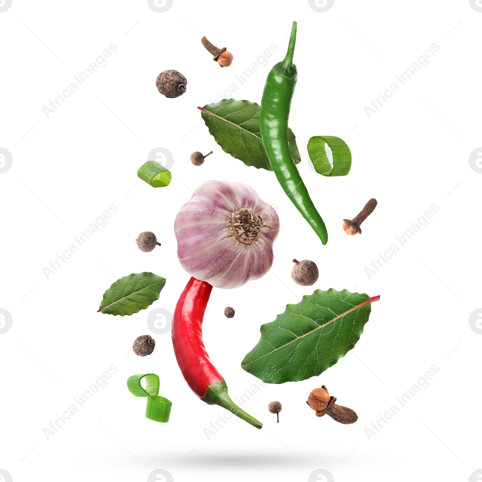 Image of Different aromatic spices falling on white background