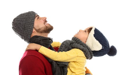 Photo of Happy father and son in warm clothes on white background. Winter vacation