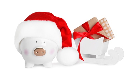 Composition with piggy bank and Christmas decor on white background