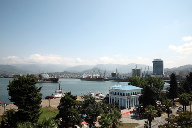 BATUMI, GEORGIA - AUGUST 28, 2022: Cityscape with modern buildings and sea port