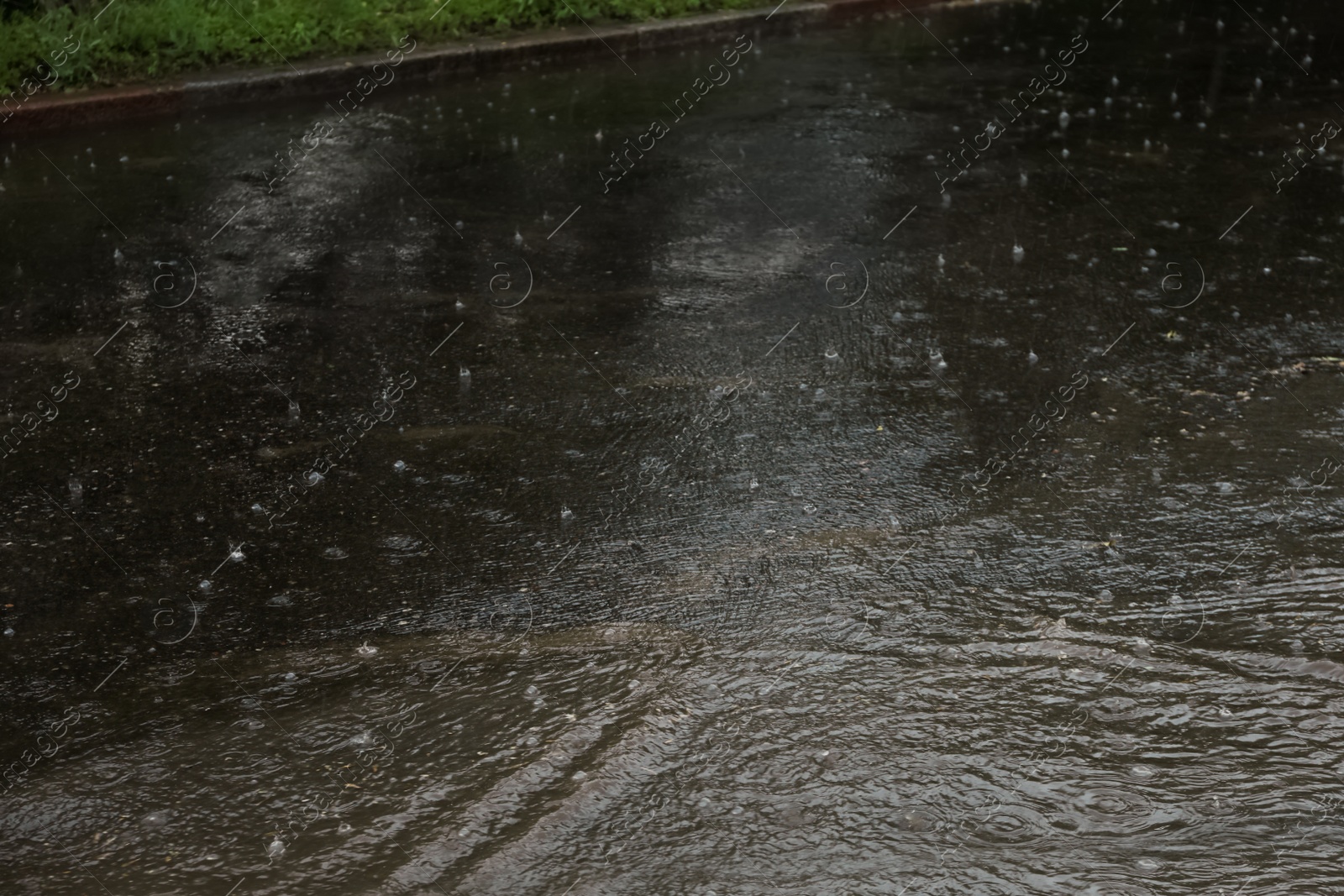 Photo of View of heavy pouring rain on city street