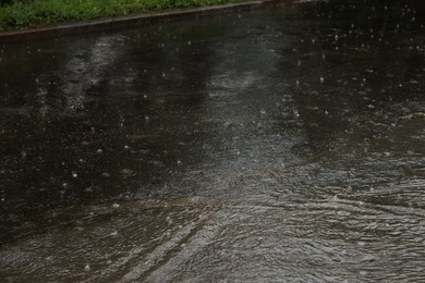 Photo of View of heavy pouring rain on city street