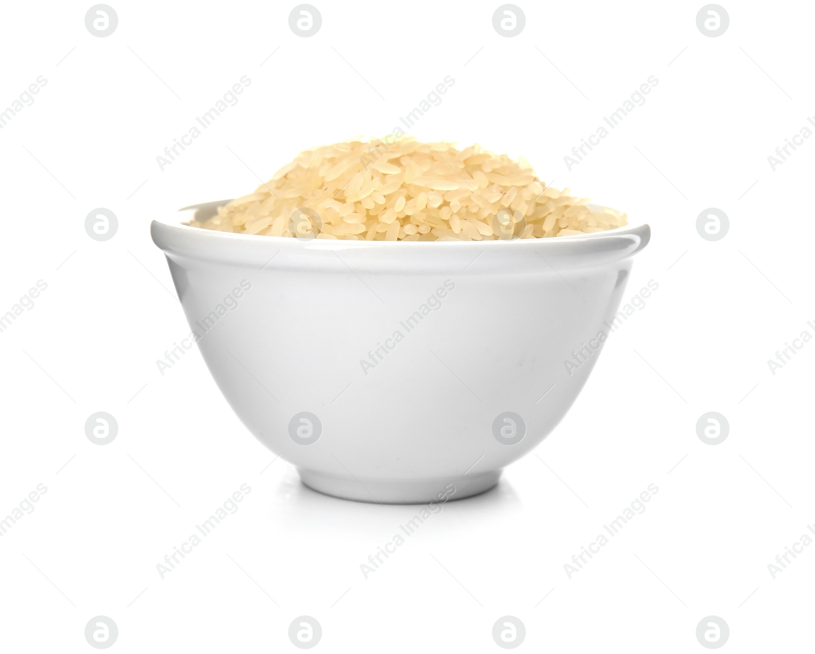 Photo of Bowl with uncooked rice on white background