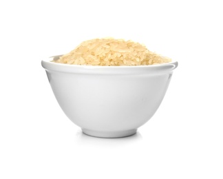 Bowl with uncooked rice on white background