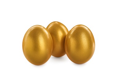 Photo of Many shiny golden eggs on white background